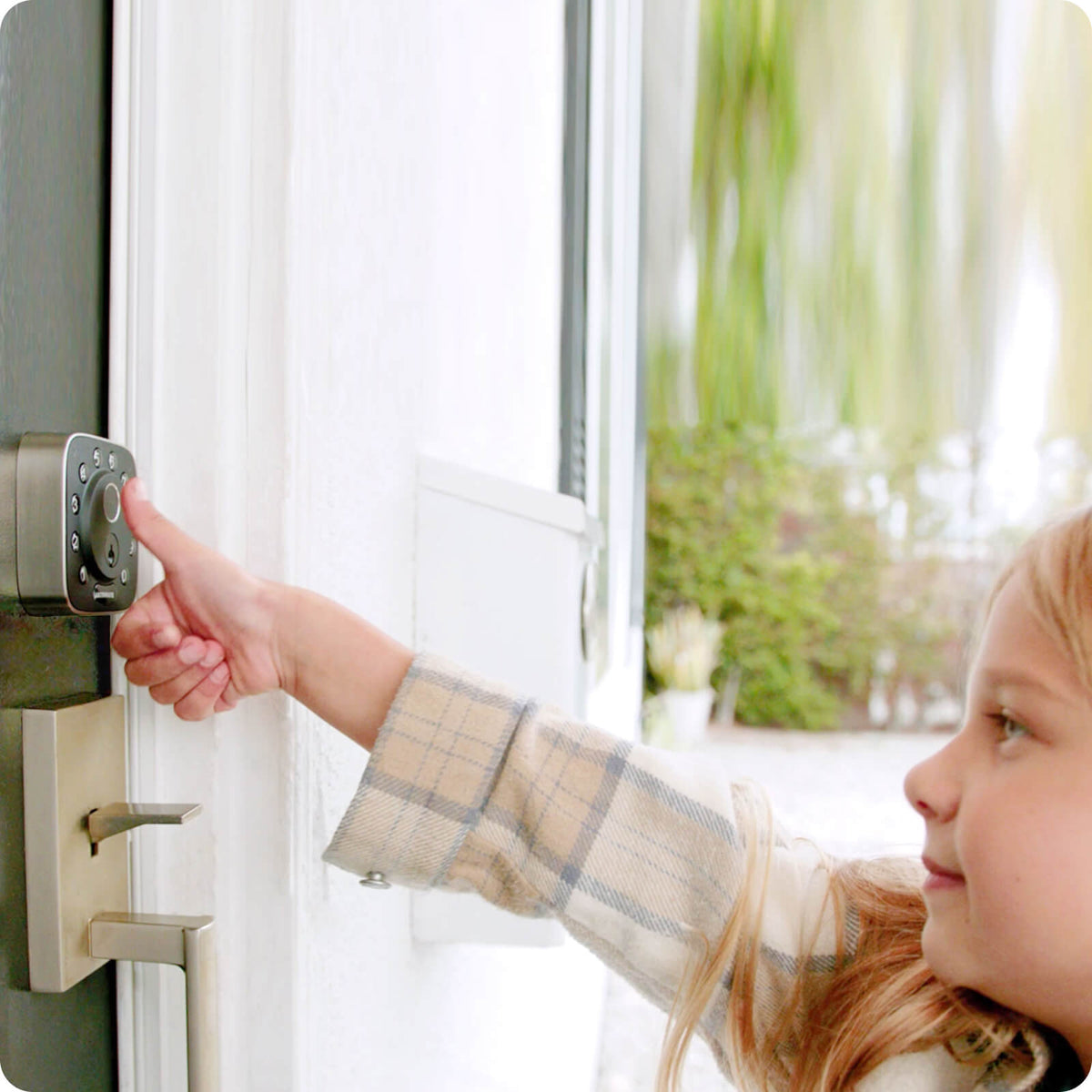 
Child using a fingerprint smart lock to unlock the front door
