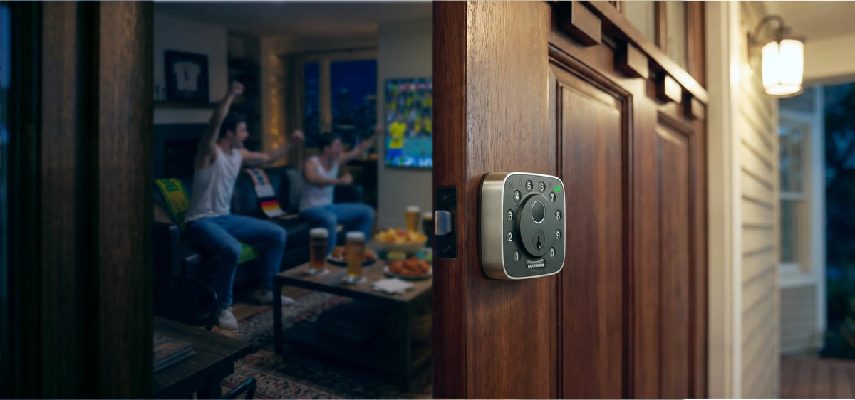 
ULTRALOQ Bolt Fingerprint smart lock securing the front door during a Match Day gathering
