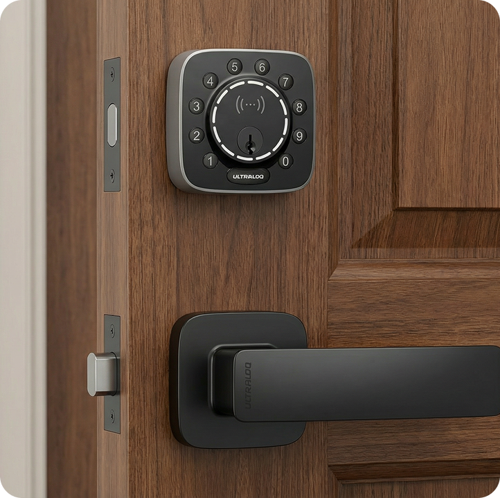 ULTRALOQ Bolt Mission smart deadbolt with black door handle installed on a dark wood front door