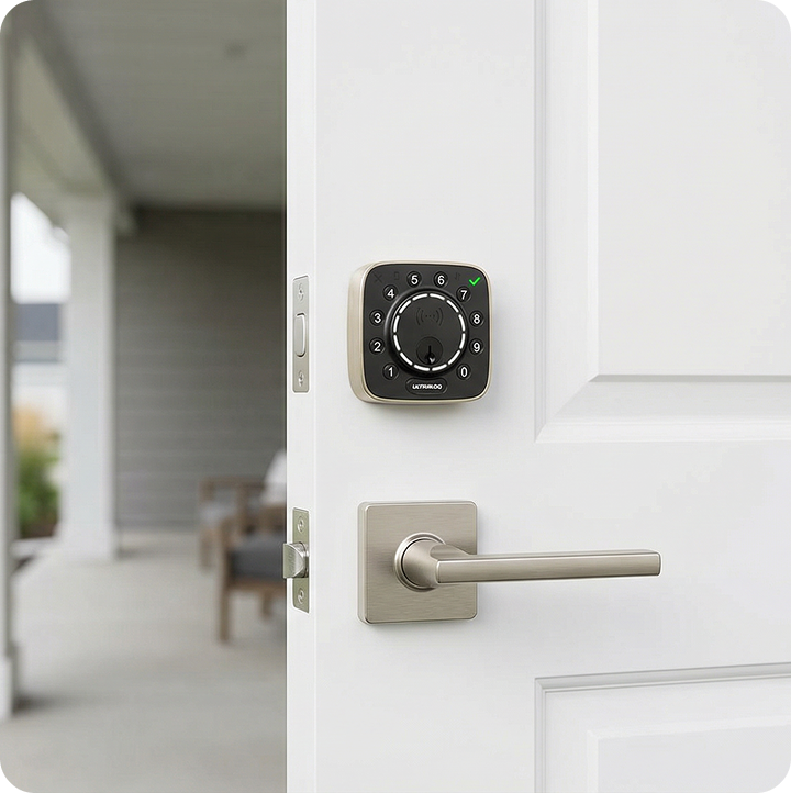 ULTRALOQ Bolt Mission smart deadbolt with silver door handle installed on a white front door