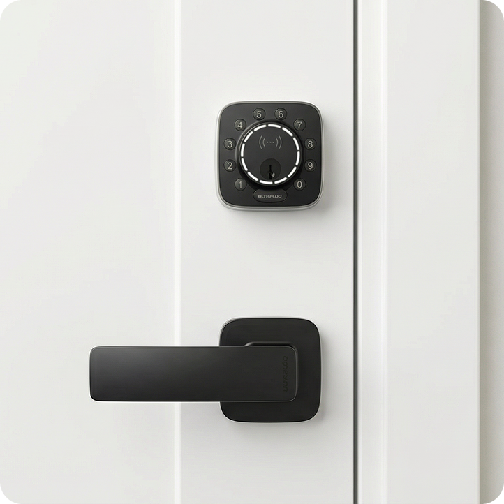 ULTRALOQ smart deadbolt with black door handle installed on a white front door